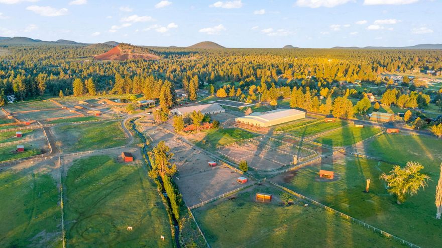 Minutes from town and miles from ordinary, Horse Butte Farms is a Legacy opportunity in the heart of Bend. Currently operating as a full-service boarding & training facility. 53-acres over (3) tax parcels. 108x210 jumping arena, 60x168 arena, 100x200 outdoor sand arena, a remodeled 1940's farmhouse, guest yurt, 6-pad 50-amp powered trailer sites and much more. $550k+ annual revenue in 2024 through a variety of established income streams. Fit for an owner-operator, high-end training operation and other dream visions. Soak-in the panoramic views from Pine Mountain sunrises to Cascade Range sunsets. Impeccably maintained and improved for ease of equine operations. (36) stalls, nine with runs, 22k feet of fencing; crossed-fenced pastures & paddocks w/ run-in shelters, automated horse waterers (inside and out) & composting operation. 33-acres irrigation rights uses the easy K-line system. Trail-ride directly to BLM. Serenity and star-filled skies awaits! Add'l 9-acre parcel MLS 220205704