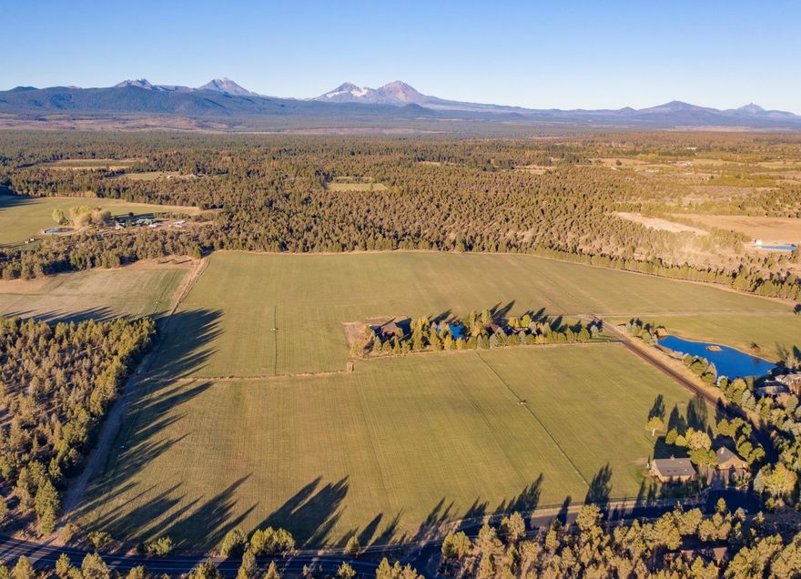 First time offering of Loco Ranch & Little Loco Ranch as one! A truly spectacular 131+ acre property w/ amazing, unobstructed views of the Cascade Mountain Range - Mt Bachelor, Broken Top & The Three Sisters. Featuring approx 91+ acres of irrigated hay fields, 30 acres of forest & an rv/shop & hay barn, just 10 min from shopping, schools & restaurants in Bend. The 3,688sqft, 3 bed/3.5 bath, main home is open, elegant & light-filled, surrounded by lush landscaping & centered around a pond w/ stunning views. The kitchen features exquisite, custom wood cabinetry, quartz countertops & an onyx backsplash, w/ an adjacent pantry, laundry/mud room. The 1,862sqft, 2 bed/2 bath, detached bonus space features a spacious, open, bright living space w/ high ceilings & gorgeous views. Little Loco Ranch includes a fully restored barn converted into a 2,126sqft 4-bed/4 bath home. Also featured is a barn/garage/shop & heated bonus space including a full bathroom.