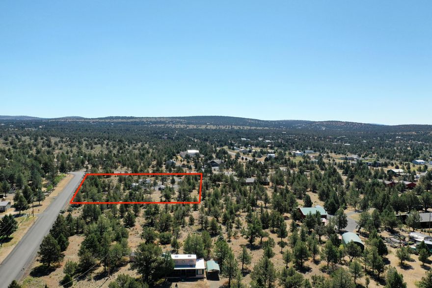 Experience rural living on this level, 2-acre lot in Prineville Lake Acres II - an excellent option for a custom home, vacation retreat, or long-term land investment. The nicely treed setting offers an easy-build site with strong solar exposure, potential mountain views, and ample space for a home, shop, or additional outbuildings. A gravel driveway provides convenient access, while power is at the street and the community water system serves the area, supporting future development plans. Enjoy the natural landscape of Central Oregon with quick access toward Prineville Reservoir for boating, fishing, camping, and stargazing. Downtown Prineville's shopping, dining, and daily conveniences are a short drive away. The neighboring lot (MLS# 220203656) may also be purchased, creating a combined total of just under 4 acres. A 10%-down loan option is available for qualified buyers - an excellent opportunity to secure Prineville acreage in a desirable rural location.