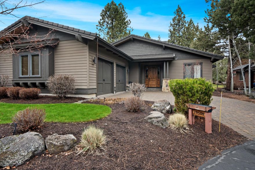 Nestled in The Woods of Broken Top, this exquisite single-level home, crafted by David Hesla for the 2013 Tour of Homes, blends Northwest elegance with comfort. The open Great Room, featuring wood beams and a stone fireplace, flows seamlessly into a kitchen adorned with a quartz island and knotty alder cabinets. An office with a built-in desk hides behind a sliding barn door, opening to a private courtyard. Hardwood floors grace the living areas and primary suite, which, along with the dining area, access a spacious, walled courtyard with an outdoor grill and natural gas fire pit, embodying outdoor living at its finest. This beautiful home boasts an oversized garage with custom storage, a landscaped front, and backs onto a lush common area. Located on Bend's desirable westside, it promises luxury and proximity to outdoor adventures.