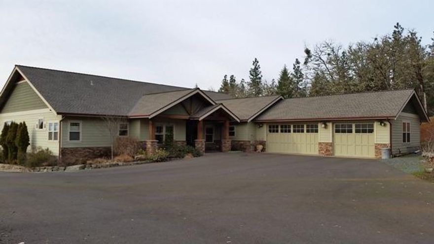 Spectacular custom home on 6+ private wooded acres just a mile from city limits, with great views of the city lights & mountains beyond. Massive hand carved archway invites you to enjoy the thoughtful amenities inside, including slab granite, hand scraped flooring, custom lighting, etc. A 122/sf patio affords views of water features, Koi pond, & landscaped yard. RV building with 14' door, generous turn-a-round & dump station. Needs appliances.