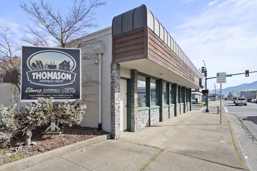 Professional office/retail building in Grants Pass Central Business District perfect for owner-user. This versatile and well-maintained single level building offers multiple conference rooms, a mix of cubicles and private offices, large windows for plenty of natural light, and flexible spaces suitable for a variety of professional or retail uses. The property includes 16 on-site parking. Current HQ for Thomason Hospitality, it's within blocks of Historic Downtown Grants Pass shops and services, this prime location offers excellent signage and visibility along 7th Street and easy access to major thoroughfares, including I-5 and U.S. Route 199.  Great location for a retail shop, satellite office or new headquarters.