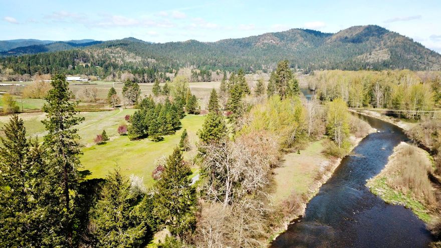 25.54 acres zoned EFU nestled along 900' of Applegate River Frontage. 3 level irrigated pastures, 2 ponds and mature trees display a park like setting. Main house 1530sf 2bd/2ba & 684sf 2bd/2ba guest house centrally located and secluded with pasture, pond, and river views.  2 large metal ag buildings consisting of 4160sf, concrete floors, insulated and constructed in 2020 along with a 2640sf barn and multiple sheds/equipment storage. District and river water rights date back to 1899. This property has so much to offer!  Opportunity awaits and not limited to your agricultural, equestrian, wedding venue or 2 family needs. All information provided is deemed reliable, but is not guaranteed and should be independently verified.