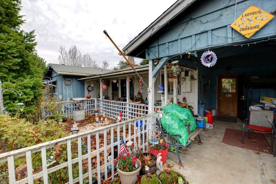 Covered attached carport PLUS a detached 2 car garage with plenty of driveway space, room for RV parking, garden area, large back yard all on a huge, fenced 0.45 acre lot.  The home has city water but also has a well that is used for the yard.  Inside is a huge family room facing south, looking over the large back yard and nice laminate floors, gas fireplace insert for heat.  This house has good bones, some deferred maintenance including needing a new roof.  Property will be ''As-Is and No-Repairs''.