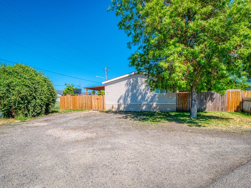 BACK ON THE MARKET! It comes with brand new roof!
This well taken care of double wide manufactured home is in a great location with plenty of space. The master bedroom/master bathroom away from the two other bedrooms allows for further privacy. The park site association rent is ONLY $475.00 MONTHLY and it includes garbage and water!! You will love the laminate flooring throughout the home and upgraded tile floor in the common bath. Very well fenced to have maximum privacy, property has two entrances through the front-left and right. The inside paint is in great conditions but if a colorful home is not in your bucket list, you can always add your personal touch and paint it to your liking. Make it YOUR home!