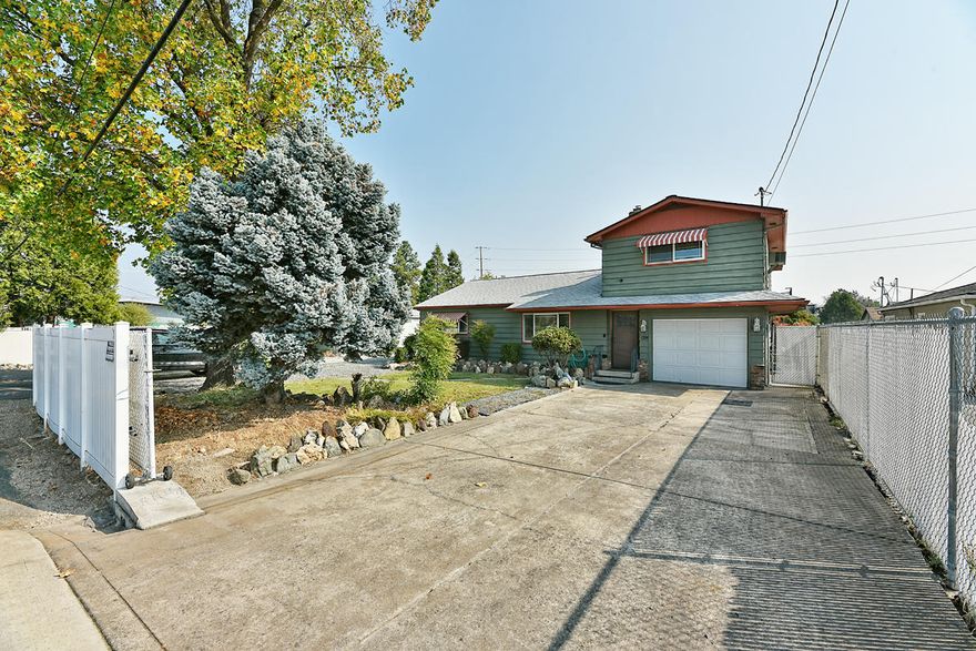 Two for the price of one! Property is in a prime location close to schools, parks, & shopping. The one sits on 1 tax lot w/ .29 acres w/ an additional .11 acre tax lot near the back of the property for a total of just under a half acre to call home. This one of a kind 3BD/ 2BA home boasts 1988 sq ft of living space. Large family room in the front part of the home as well as a nice sized living room towards the back of the home w/ a stunning bay window. Kitchen has been updated w/ granite counters, two tone painted cabinets, newer stainless steel appliances, sink, faucet, & laminate flooring. Master bedroom also has been updated w/ newer carpeting in the last year. Homes HVAC was updated about 3 yrs ago.  Moving outside is a completely separate insulated finished workshop w/ a large attached RV carport w/ full hookups. Two driveways offer easy parking, plus a large level lot behind the detached workshop for extra parking or future projects. This one won't last long!