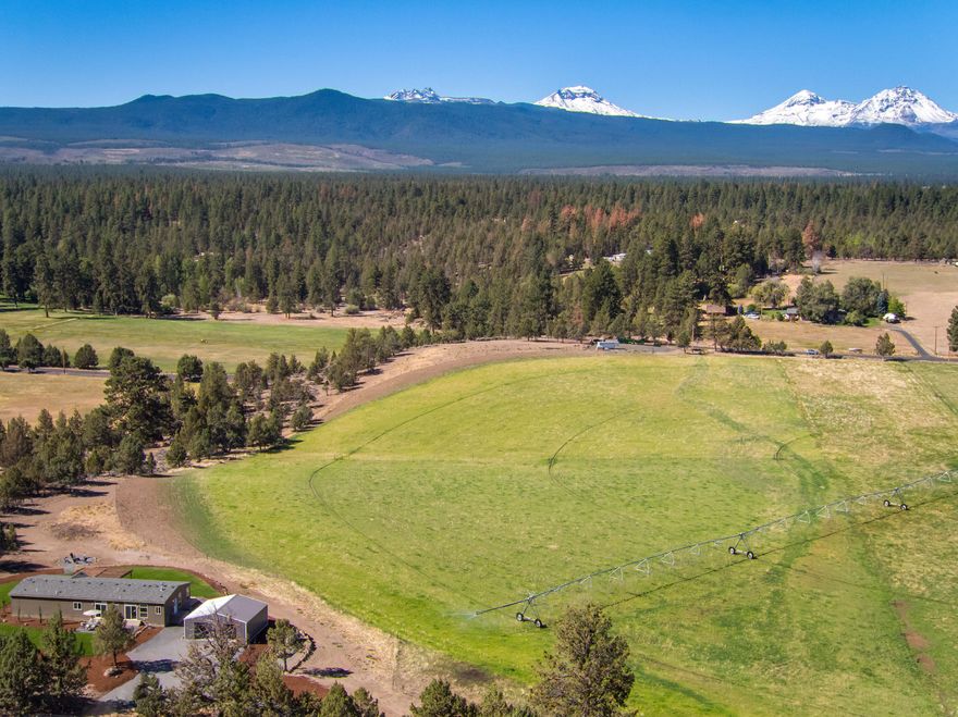 Panoramic Cascade Mountain Views from Tumalo acreage property. Property is 39.04 acres, 3 tax lots, with 33 acres TID water rights irrigated with a pivot. New single level 2400 sq ft home with an open floorplan, 3 bedrooms, 2 bathrooms, office, living room, family room, master suite, utility room, quality finishes throughout and a two car garage. Terrific outdoor living with decks, landscape with sprinkler system, fire pit and stunning views overlooking the green pastures and mountains. Property is fenced, gated, ready for livestock and is close to public land for mountain biking, hiking or riding. This property is ready for any Central Oregon lifestyle!