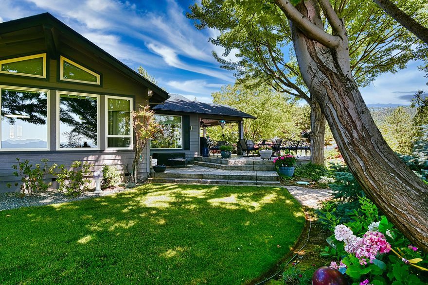 First time on the market! Gardeners delight! 1990 W L Moore built single level home with absolutely stunning views, flower gardens and treed walking paths.  3bd / 2ba with sky lighting and ceiling fans in all of the rooms.  Large spacious kitchen w/ kitchen island, stainless steel appliances & upgraded cabinetry. Beam central vacuum system. Granite counters and tile flooring. Incredible floor to ceiling tinted windows to capture the 180 deg. valley views.  Large entertainment patio from the kitchen and dining room. Oversized garage w/ built in storage cabinets. 40 GPM well per Seller and a 2 yr old well pump. 3 yr old roof. Timed water systems in all area of the gardens. RV hook up. Nice outbuildings for additional storage including a large chicken coup. Gated and fenced.