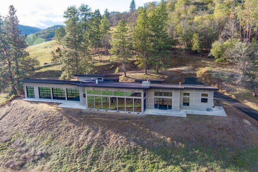 ''The Cloud 9 Ranch'' on 40 acres, 20 acres irrigated through TID, gently sloping pastures, w/South Easterly exposure, 2 barns. Electric gated entry w/white vinyl fencing, paved driveway. Fully fenced & cross fenced. Main home is very modern w/3bdrm, 3.5 baths, 3879 SQ FT w/high end finishes & amenities. Open lg living w/16' vaulted ceilings w/floor to ceiling windows overlooking the valley, orchards & vineyards. Cherry wood floors, great rm w/efficient Rumsford wood burning fireplace w/floating mantel. Kitchen w/Wolfe 6 gas burner w/grill, Quartz & Stainless counters, custom cabinetry, lg island, built in fridge & 2 dishwashers. Master suite w/lg walk in closet, custom tile shower, soaking tub & fireplace. Heated Indoor salt water pool, waterfall w/3 floor to ceiling glass doors overlooking the views. 2 separate office/hobby rms. 2-360 SQ FT cabins w/bathrooms. Original Farm house 3/1, 1440 SQ FT (permitted for storage per county)
