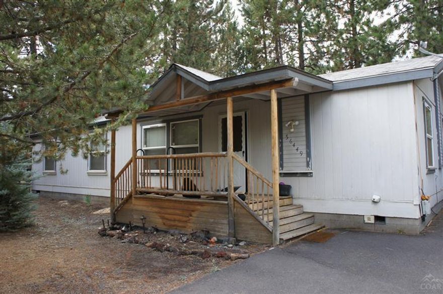 Get away from the hustle and bustle of city life! This manufactured home is nestled in the trees on a .5 acre lot with a huge covered RV garage/shop with drive thru access. This property is completely fenced and gated. The home is 1512 sq ft, vaulted ceilings, large kitchen, utility room and large covered back deck for entertaining. Priced to sell! Don't miss your chance to own at this price!