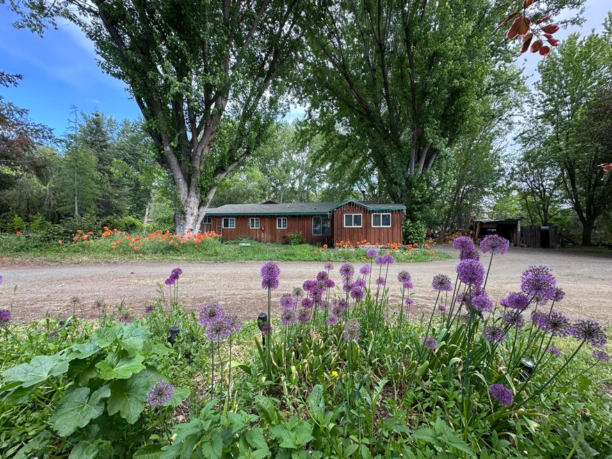 Charming 3-Bedroom Home bordering Beech Creek.
This delightful 3-bedroom, 2½-bath, 1,504 sq. ft. home is nestled alongside Beech Creek. The property has been tastefully updated and features a spacious living room, an inviting dining room, an enclosed porch, and a pantry.
Step outside onto the expansive deck and unwind while enjoying the soothing sounds of the creek. This property is truly a gardener's paradise, boasting apple, pear, and cherry trees, as well as raspberries, blackberries, rhubarb, and an abundance of **annual flowers and bushes.
The large lot also includes a 1,080 sq. ft. shop, a pergola with a firepit, a hot tub, a pumphouse with a shallow well, a greenhouse, and chicken coops with spacious runs.