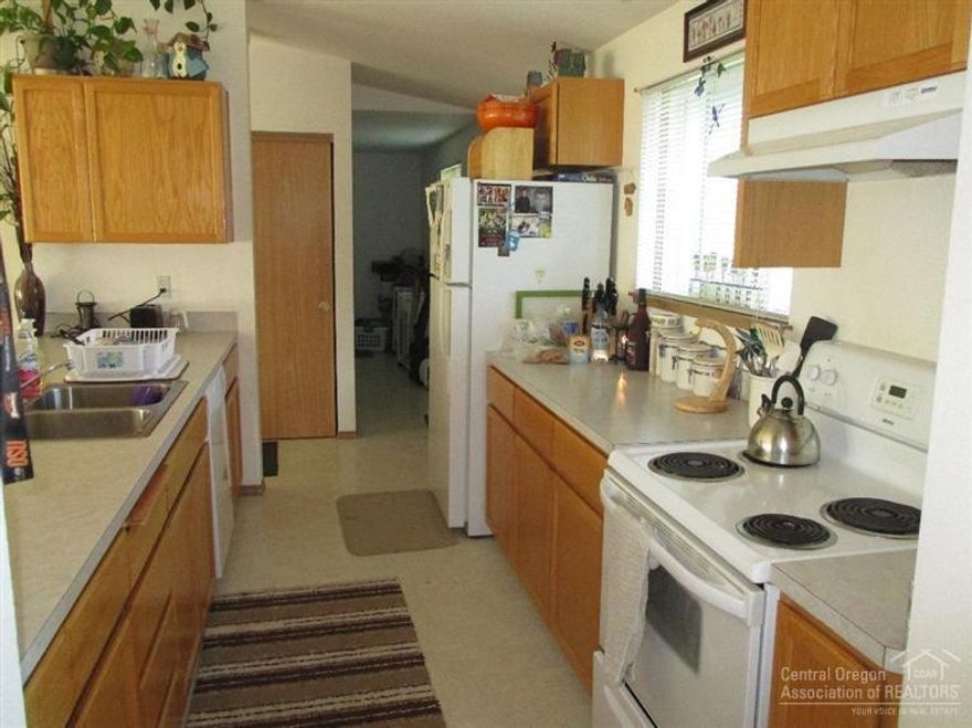 Priced right for this country home with room for your horse and irrigation for the hay. Listen to the geese pass overhead at 6 to 7 pm at night heading for the lake. Nice open single level floor plan with master and bathroom on one end and two bedrooms and bath on the other. Nice sized deck for outdoor living. Fruit trees too.Come enjoy this home.