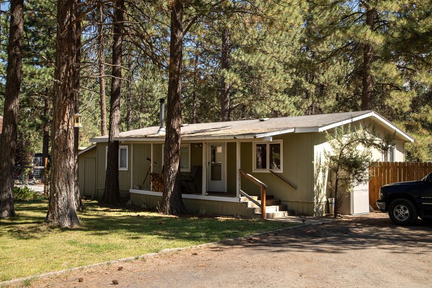 Well Kept Cozy 3 bedroom 2 bath 980 sq ft Manufactured home located in Deschutes River Woods, minutes from the Old Mill.  Property includes a stick built detached single car garage with attached permitted addition with full bathroom, that could be used as a studio/office with separate parking and fenced yard area. The nearly  1 acre lot features a nicely landscaped front yard with numerous mature trees.