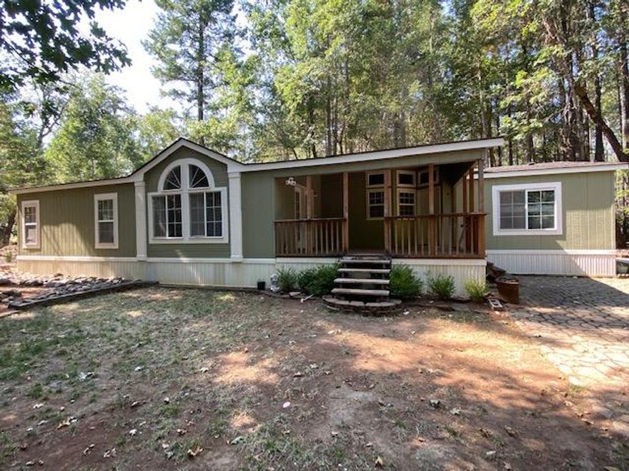 Welcome home! Located at the end of a cludesac. This nicely wooded flat and useable 5 acre property with a very nice 2,282 sq. ft. 3 bedroom 2 bath manufactured home with brand new paint in and out, new roof including all new plywood sheeting and a nice 1008 sq. ft. shop is ready to be your new home. Make your appointment today to view this property.