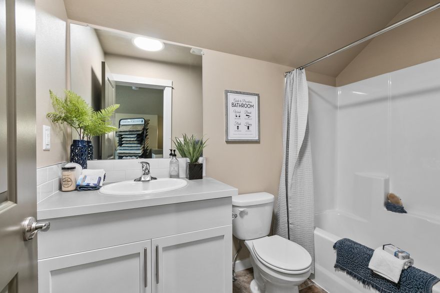 The 2042 square foot Targhee is an efficiently planned two-story home popular with those in need of generous comfort. The home's alley-accessed garage creates amazing street appeal. The first floor is home to an expansive living room, large dining and adjoining kitchen featuring a useful island. The large private master suite boasts a generous dual vanity bath with a spacious closet, while the other two sizeable bedrooms, one of which can be converted into an optional den, share the second bathroom. Upstairs, an enormous bonus room can be used for a host of purposes, including an optional fourth bedroom and additional bathroom, and puts the final touch on an extraordinary home.