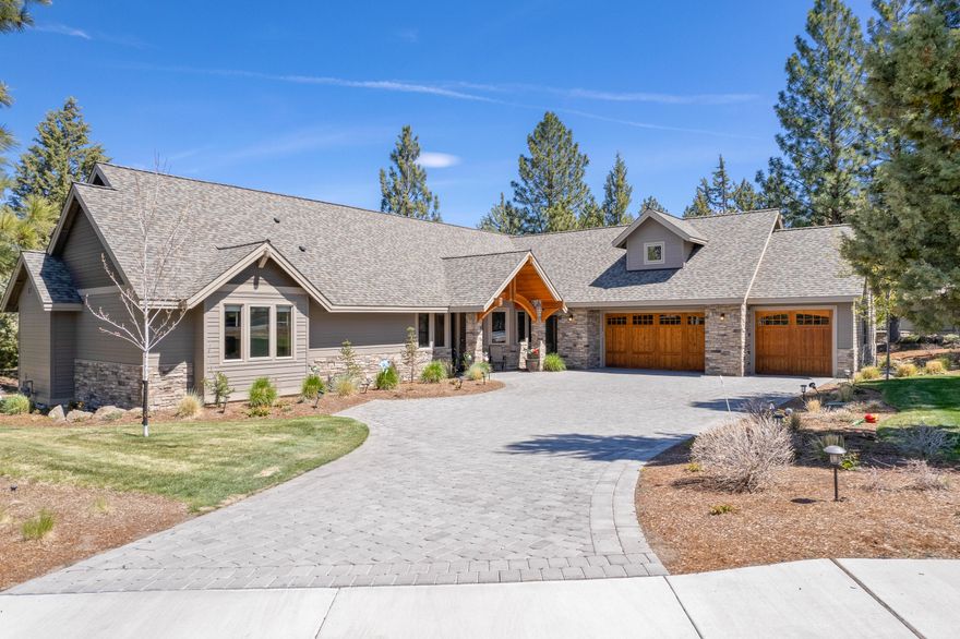 Stunning home built in 2017 perched on top of Awbrey Butte on quiet cul-de-sac. Large half acre lot with level paver driveway and plenty of space to park your vehicles in the 3 car garage. Entering the foyer, the first thing you notice is the large bank of windows opposite the entry way showcasing the private treed views. Large office off the entry with peek a boo MTN views. This open floor plan includes a generous great room w/cozy gas fireplace and hickory wood floors, an ample kitchen that boasts African Mahogany cabinets, built-in double refrigerator/freezer, an expansive island, and large corner windows over the sink. Single level living with the exception of the second story theatre room equipped with wet bar. 3 bedrooms on main with an additional exercise room that can double as a 4th bedroom. Both full bathrooms have radiant floor heating and walk in showers. Primary bedroom has huge walk-in closet. This is the Awbrey Butte home you have been holding out for!