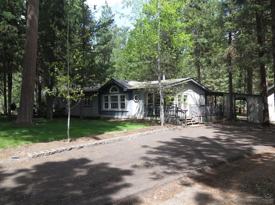 Located in desirable Ponderosa Pines, this spacious and loved home features a dream kitchen that has enormous counter space, skylight, tons of cabinetry/storage, cooktop, wall oven, dishwasher and a Morning Room for breakfast and sunshine. Great Room concept with a Dining Area off the kitchen and slider to a huge wraparound deck and view of tall pines. Great Room has lovely large windows with views of front yard and pine trees. Recently remodeled hall bathroom has beautiful cabinetry. Master bedroom suite has both oval soaking tub and separate shower, double vanity and lots of natural lighting. Circular drive with oversized double car garage and very nice finished loft...could be man cave/she shed/???. Bounded on 2 sides by common areas, this is a very private lot. Covered wood shed, RV ramada and finished carport bring more storage to the package. This wonderful property just needs your personal touches to make it your own. Call TODAY before it's gone