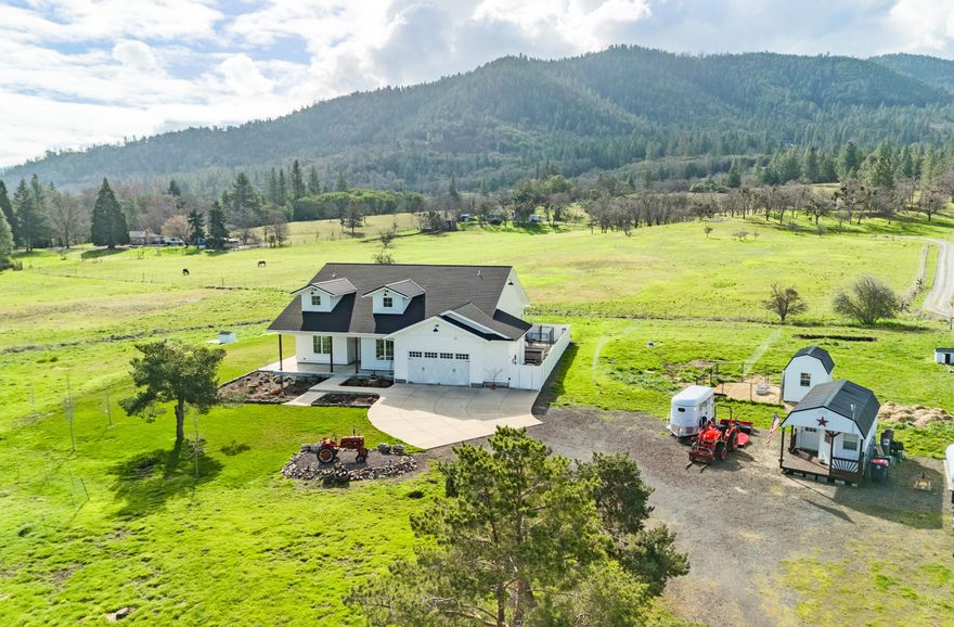 Live an Oregon Dream in this gorgeous, Asher built, modern day custom farmhouse. Situated on a level 5-ac. lot in the beautiful rolling hills of SW Medford. This single level floor plan, w/ 3 bedrooms & 3 bathrooms are nicely separated.  The owner suite has a spa like bathroom, dual vanities, soaking tub, tiled shower & walk-in closet. A 2nd bedroom has its own en suite bathroom & there is an office/den. The home is open & bright w/ high ceilings, custom hardwood floors, & windows that capture the surrounding views & natural light. The kitchen has quartz countertops, s/s appliances, a huge island eating bar & pantry. Artesian well w/ over 25 GPMs (tested '22). Also, a water catchment cistern storage tank for outdoor irrigation needs.  Whole house filter, UV & RO systems. Entire property is fully deer fenced & gated. Two outbuildings offer room for storage or animal/farming hobbies. 400 amp service, solar & home is Earth Advantage & Energy Star certified. Start living your dreams now!