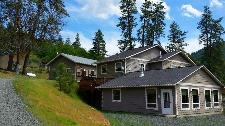 Mountain Views! 3000+ sf home w/ wrap around deck. Built w/ energy efficiency in mind w/ lower level hydronic floor heating & 5 unit mini split heating/air throughout. Open entry w/ wood accents & large open living area w/ Jotul woodstove, slate hearth & a 100 yr old reclaimed mantel. Chestnut floors, large open kitchen, dining room w/ great natural light & a 1/2 bth. Lower level includes a fantastic master suite w/ walk-in tile shower, glass doors leading to private living space & the 2nd bd all w/ incredible 12 ft. ceilings. Around the corner is a second living area w/ bd & bth, an open kitchenette/dining/living area w/ wood stove & mosaic hearth. Lots of windows, private entrance & a small private patio. Electronic gate w/ circular drive allows easy access to both levels of home. Sunny 3+ acres backs to BLM & great hiking trails. X-fenced w/ established garden beds & set-up for animals. 1000 sf. garage/shop includes studio w/ bath for more living & hobby space.