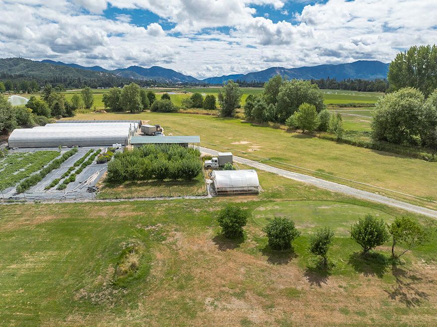 Looking for the perfect opportunity to buy a successfully working produce farm? Look no further! This gorgeous property features 4 commercial greenhouses - 2 of which have propane heat, and 1 with a fertilizer injection system, 10,000 sq. ft. fenced garden area, 6.16 irrigated acres from a 1935 Water Rights Certificate from Dutcher (AKA Lathrop) Creek, and zoned EFU. There are multiple fruit trees: plum, pear, apple, cherry, and fig, and that's not all! There is separate Ag power (200 Amp 3 phase), RV parking with power and water, a large barn, a 12' X 16' storage room, 1100 sq. ft. shop with attached carport, and as a bonus, a quaint 1162 sq. ft., 2 bed, 1 ½ bath home. Property currently produces fruits and vegetables for multiple Farmer's Markets.