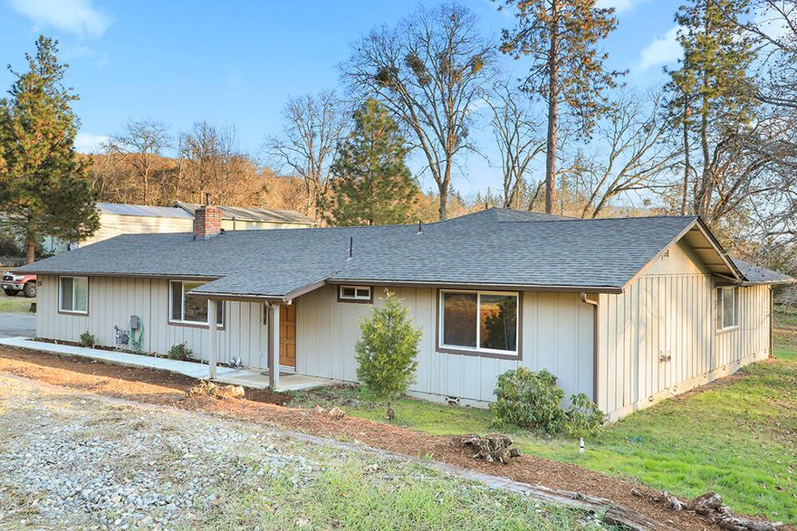 Fantastic home on over half an acre in NE Grants Pass with inground pool and huge backyard! You won't want to miss out on this charming and spacious 3 bed/2 bath home with both living room and large, awesome great room! The kitchen is well laid out and includes double ovens for the serious chef! Outside, cool off in the 16' x 36' pool during the hot summer or relax in your hot tub on a chilly winter evening. There is even a half basketball court to enjoy! The owner has taken excellent care of the home and made many recent improvements in the last few years including newer exterior paint, hardwood floors, granite countertops, tile flooring, double paned vinyl windows, water heater, garage door, well pump, pressure tank and more! Roof was new in 2015. The shed with 12' x 16' concrete pad was added in 2021. Come take a look at this one before it's gone!