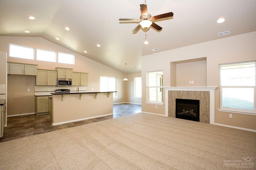 Gorgeous single level open floorplan on large canal property. Cascade Mountain and Smith Rock views. Home features a 4ft garage extension, fireplace, covered alcove, standup shower and black appliances with a gas range.