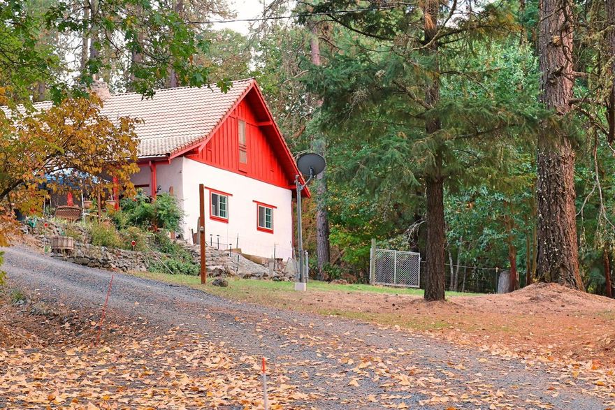 Tired of City Living? Welcome Home! Enjoy the serenity of country living just a short drive from town. This solid built split level adobe home, sits on over 15 private acres backing B.L.M. land. Enjoy a hike through the hills and harvest morel mushrooms in the spring. You'll love cooking in a gourmet kitchen with tons of storage, granite counters, and an island with electricity that opens into the dining area. The living room has beautiful wood floors with high ceilings, a stone fireplace and a 3 year old Avalon Arbor wood stove to keep you warm and cozy. The rough lumber staircase leads to the two bedrooms and half bath upstairs. The covered patio is a plant lovers dream with shade, sun, and the sound of a water feature. There are outbuildings to store your toys and a covered carport with a shop. This property has it all; land, privacy, work & hobby space, possibilities for animals, room for toys and a beautiful home.