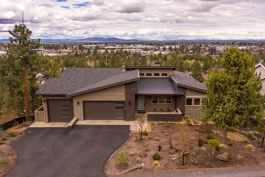 Amazing custom contemporary home w/a huge panoramic view. Built by Desert Sage Homes w/high quality finishes, fantastic modern detail & level entry. The lines of the architecture are simple, yet sophisticated. The vaulted great room, with sliders that open onto a huge view deck, is perfect for entertaining. The engineered walnut floors enhance the chic style. All essential rooms are on the main floor for easy living. The kitchen is adorned w/solid quartz counters & contemporary soft-close cabinets. The main floor's primary bedroom suite has quartz double vanity, large shower w/2 heads, & a walk-in closet. Also on the main floor is a 2nd en-suite BD w/large closets + a full bath. Both baths have amazing tile work and heated floors! The 3rd BD up can double as an office. The lower level has an en-suite bed/bath, an exercise/media room & view deck, PLUS a 648 sq ft unfinished room for hobby or storage or finished out.  3-car over-size Gar. Total sqft 3414. Close to parks and river trail.