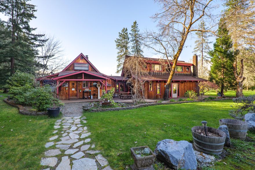 Vertical Horizons Treehouse Paradise! Situated on nearly 23 acres, this gated rural property is home to a one-of-a-kind permitted bed and breakfast, perfect for Airbnb, VRBO, or short-term rental income. Four unique treehouses dot the hillside, each with its own charm. The main house offers a peaceful retreat surrounded by lush lawns and flowering fruit trees, ideal as a private residence or the main lodge for guests. The property features a large fenced pasture, greenhouse, detached garage, spacious barn with stalls and turnout, carport, wood storage, and more. A true blend of ranch and resort living, it's perfect for those who value rural life—growing your own food, raising livestock, and enjoying privacy—while benefiting from an established income-producing resort. Located in the scenic Illinois Valley with a mild four-season climate and easy access to the Illinois River and the stunning Oregon Coast.