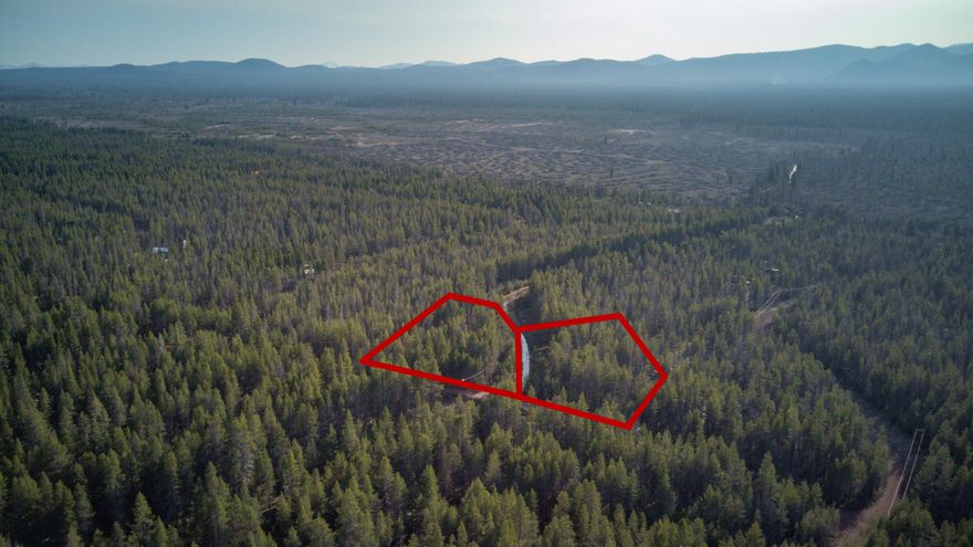 Two adjacent, tree-covered lots in the scenic Mt. Scott Meadow subdivision—sold separately or together (1.1 & 1.4 acres). Scott Creek runs through the property, adding tranquility and charm. Nestled in nature yet accessible, these parcels are just a short drive from Crater Lake, Diamond Lake, and the Fremont-Winema National Forest. Power is nearby with telephone poles running along Cloudcap Drive, making development easier. Ideal for a private retreat, basecamp, or investment in Oregon's wild beauty. No HOA.