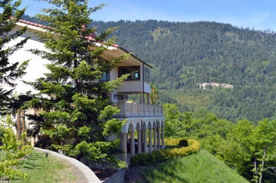 Magnificent 80 acre country villa located at the southern end of the Rogue Valley and just minutes to downtown Ashland. Panoramic views of the valley and Emigrant Lake can be enjoyed from the property. Each stately bedroom is en-suite and shares the same stunning views. Professional quality dream kitchen, luxurious outdoor pool and incredible outdoor kitchen, extensive use of walnut, marble, copper, custom designed & crafted iron railings, exquisite custom eight foot solid wood doors & stunning crown moldings. 24' high ceilings & grand staircase combine to create an extraordinary spacious and warm home. Raised bed gardens, amazing greenhouse, plentiful fruit trees in addition to 1 acre in grapes currently being sold to a local vintner. Enjoy having your own boutique winery or allow the property to be taken care of and managed.