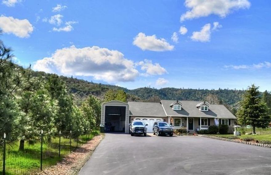 Country living close to town! This well maintained home is located well off the road on a paved driveway with a gated entry on just under an acre of level land. Has a great 70 GPM well per well log! The home features a nice open plan with 3 beds & 2 baths, vaulted ceilings, living area as well as a family room with a gorgeous island kitchen with breakfast bar, slab granite counters, newer upgraded stainless appliances with a convection oven, beautiful cabinetry and tile floor, plus tile and granite in both baths. Sliding doors from the master bedroom, kitchen, and the family room lead out to a covered patio with Koi pond & hot tub, and a roomy back yard. New interior paint, an outside storage shed, plus a 16' x 40' covered RV port and a 2 car attached garage that is fully insulated with heat & AC. A nice pasture to the front of the property makes this a great place for small critters. This is a very desirable location on Old Stage Road with quick access to Interstate 5.