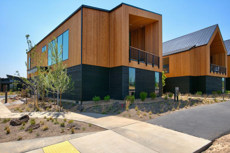 Enjoy uncompromising craftsmanship and finishes throughout this high desert oasis with panoramic views of the Cascade Mountains. Nestled in Tetherow, the Chalet Neighborhood is a collection of 12 beautifully designed townhomes with a mountain modern aesthetic and a touch of European design. Envision the ultimate Central Oregon lifestyle combined with world-class resort living: including Top-100 golf, a year-round pool and fitness facility, on-site restaurants, hiking and biking trails literally steps from the front door and so much more! Soak up the abundant sunshine in the light and bright open concept great room by the gas fireplace while fresh mountain air flows in through the oversized sliding doors that seamlessly integrate the indoor and outdoor living areas. Spacious kitchen features Thermador appliances, pantry, island sink and breakfast bar. Primary suite with large walk-in closet and luxurious bath. Two additional full suites and laundry room on the entry level. 3-car garage.