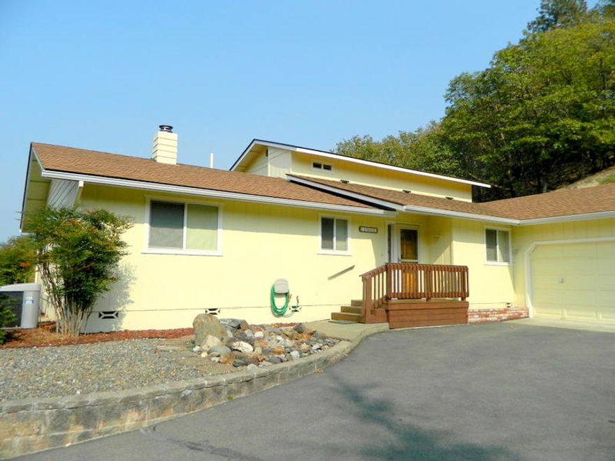 View home on 4.8 acres.  Outstanding views of Grants Pass and city lights.  Gated entrance & paved driveway.  Great room with fireplace.  Kitchen has oak cabinets and corian counter and newer appliances.  Master bedroom and master bathroom on upper level with deck and views.  2 bedroom and hall bath on main level. Laundry room and 1/2 bath.   2190 Sqft built in 1990  Double garage with 7'x14'workshop. Wooded lot.