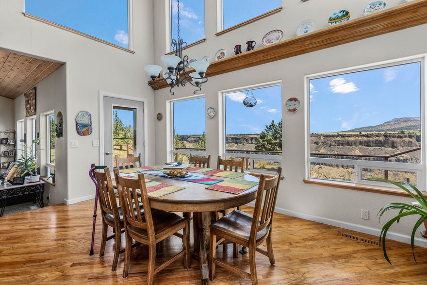 Enjoy the breathtaking views from this custom home perched on the upper rim of Crooked River Gorge.  The 2-story bank of windows frame ''The Ranch's'' original Ranch House, the stunning cliffs and panoramic views.  The well laid out kitchen features granite tile work, double ovens and custom cabinetry.  Relax in the Living Room with its propane stone fireplace and craftsman vaulted ceiling.  All 3 bedrooms are on the ground floor with the primary bedroom having private access to the wrap-around deck and hot tub.  Enjoy the cheerful primary bathroom with its hand painted double sinks and glass brick shower stall.  The upstairs loft is a large bonus room with its own full bathroom and private office and also highlights the beautiful view through the bank of windows.  The 2-car garage includes a workshop area.   Freshly painted exterior,  new roof, and the heat pump is only 2 years old. Come hang your hat in the resort community of Crooked River Ranch.