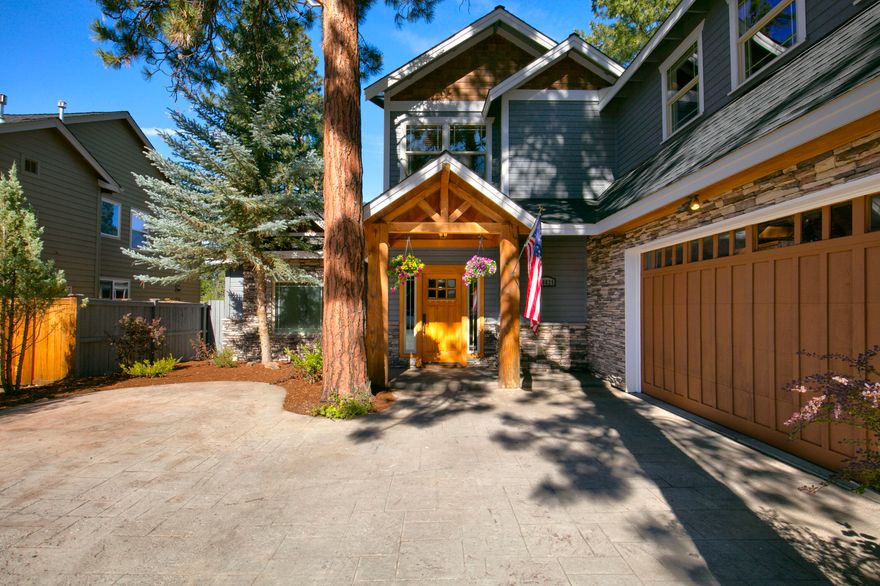 This exquisite SW Bend home with a rare, versatile floor plan! Offering 4 bedrooms (primary on the main), dramatic two-story windows, and a spacious bonus room. The great room is bright and welcoming with a gas fireplace, while the kitchen boasts Mt. Bachelor views, abundant cabinetry, island with gas cooktop, and bar seating. Step outside to a covered patio, hot tub, water feature, and fenced yard. The main level also features a dining room or office. Upstairs includes a bonus room, 3 bedrooms, and 2 full baths. The luxurious primary suite has a T&G ceiling, fireplace, jetted tub, tile shower, dual sinks, and two walk-in closets. An oversized 2-car garage with extra parking, owned solar panels for low utility costs!