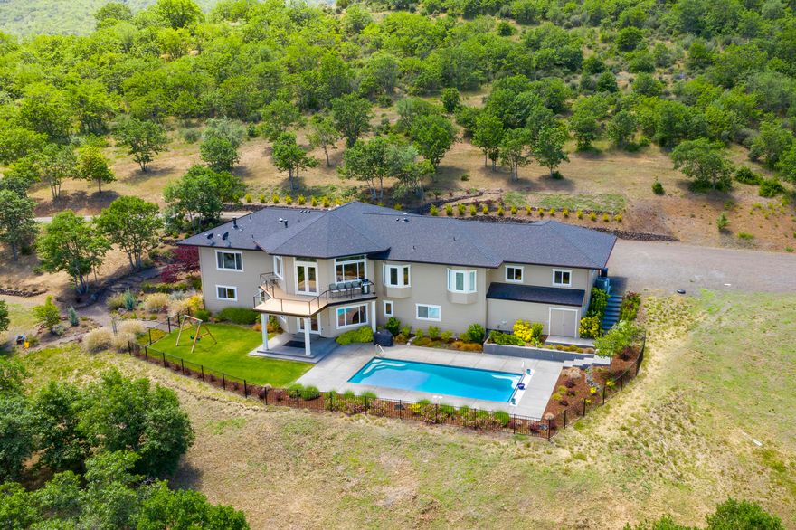 Live the Ashland dream on 12.29 private acres. Perfectly perched w/views 
at every turn, this home was custom built w/no stone left unturned.The 4BR/4.5BA 4101SF home features main-level living at its best..maple flooring, large windows & gourmet kitchen! Open to the kitchen is the dining area, living room w/gas FP & vaulted ceilings + viewing deck. The master suite w/an ensuite bath, walk-in closet + office. Also on the main level you'll find a powder room, 2nd bedroom, bath + laundry/mud-room. On the light-filled lower level you'll again be greeted by views galore. A great room w/direct pool access & large bar area allows for a nice separation for guests. Also on this level you'll find a 2nd master w/ensuite bath, 4th bedroom & add'l bath. Large bonus storage areas are also on this level.  A salt water pool w/electric cover complete this home w/solar + heater for transition months. Irrigation system, propane generator & 5KW's of solar are just the beginning. See attached amenity list