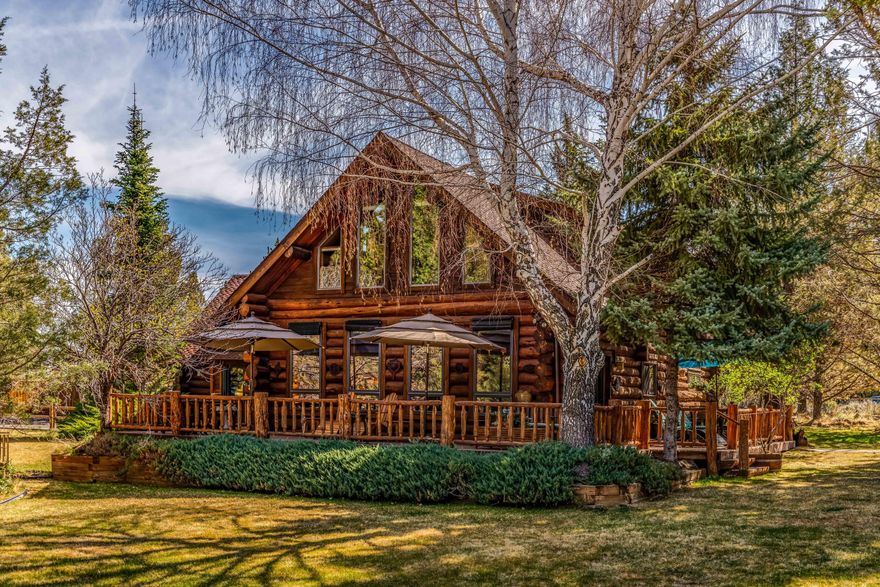 Beautiful custom log home situated on 2.46 acres in desirable Conestoga Hills. Only 4 miles SE of Bend. This home features 3 bedrooms, 2 baths, and upgrades such as tile, reclaimed treslewood hardwoods from Salt Lake, newer stainless appliances, stain glass accents, and much more. Large primary suite with a private deck overlooking peaceful grounds and wildlife, spacious guestrooms w/ separate entrances, a comfortable loft area and vaulted living. Situated off a quiet street, this stunning property also offers two driveways, paved guest parking for a RV and a large 2040 sq/ft shop with inside RV parking and parking for (3 plus) cars.  Useful and private flex space above shop w/ a full bathroom, perfect for guests or a caretaker.  A magical setting with abundant deck living to enjoy the water feature and wildflower gardens.