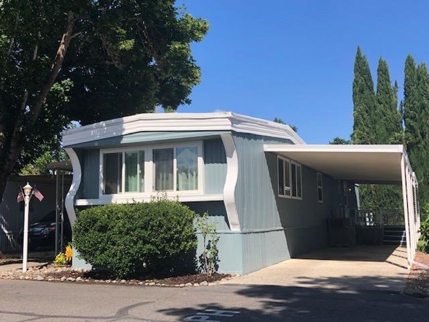 Beautifully remodeled & updated - MOVE IN READY! This 55+ community has a peaceful feel and is just a short distance to town. New paint inside & out, new flooring & windows, very light and bright. 2 year warranty left on 3 year old heat pump. Park is situated on river with personal use privileges. This is not your ordinary home and includes a garden area with pear tree and beautiful roses that you can enjoy from either covered patio that includes new carpet. Storage shed has electric and shelving too.