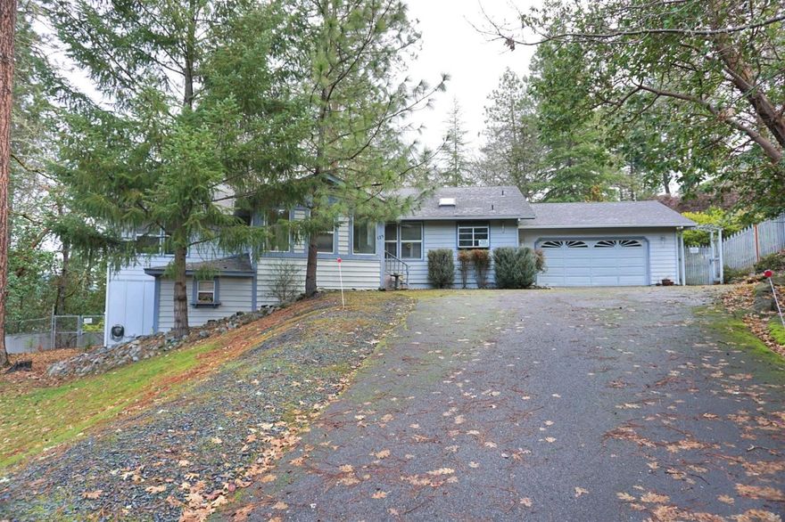 Lovely tucked away 3 bedroom, 2.5 bath, with approx. 2036 sf. on 1 acre in the county, but less than 5 minutes from shopping and health services. The living room is bright and open with several sliding glass doors leading to the back deck with a gas fireplace as the focal point in center of the room. Master bedroom is spacious with large master bath and 2 separate closets. New laminate flooring in living room, dining room, kitchen, and utility room. The partial basement offers a ton of extra storage and there is plenty of room for parking! District 7 Schools! Come check this one out! All information is deemed reliable but not verified; anyone considering purchasing this property should perform their own investigation into the uses and condition of the property.