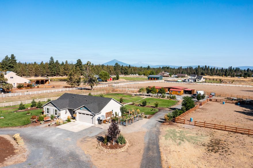 Beautiful 4.75 acre fenced and irrigated horse property located in the desirable Sisters school district. This, like-new single level, 4 bedroom home boasts open concept living w/vaulted ceiling and good bedroom separation. The wonderful kitchen has dark cabinets, island and pantry. Covered back patio and expansive lawn. Enjoy 3.5 acres of irrigation, fenced X fenced, 6 stall barn w/water & power, tack room, shop/tool shed and so much more at this well planned horse facility!