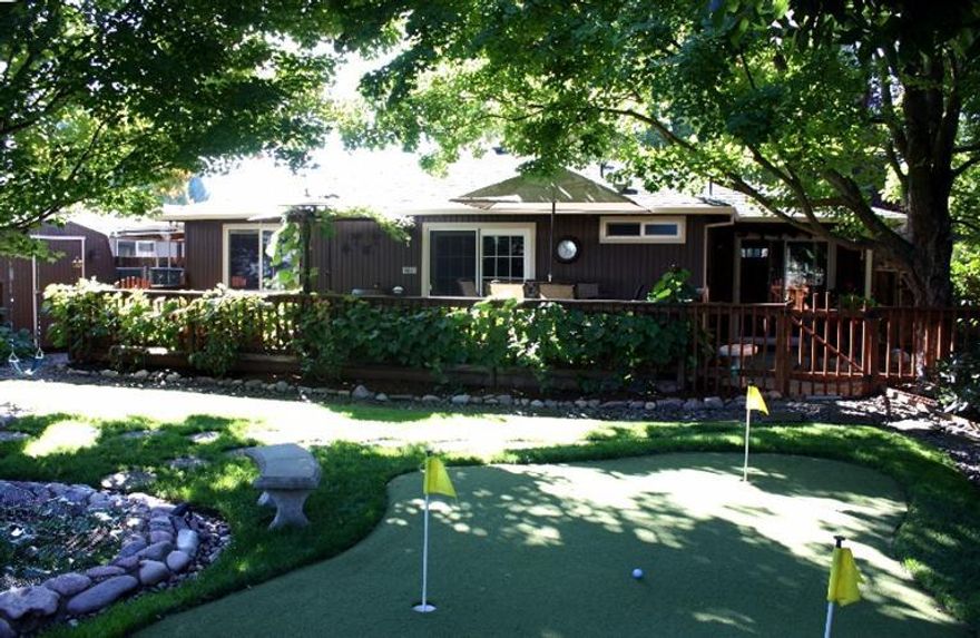 The perfect retreat ... yes, this home truly has it all! Classy and comfortable on the inside, with a welcoming warm feel throughout the flowing 3 bed / 2 full bath, single level floor plan. Meticulously maintained, with a newer roof, paint inside and out ,and a convenient, quite cul-de-sac location. There's room for a small boat or ATV in the R.V. parking area.... but you'll have a hard time ever wanting to leave with the a back yard as spectacular as this one! Starting with the beautiful, inviting in-ground salt water pool... complete with solar heat for enjoyment that lasts for months. Next is a wonderful propane fire pit ... cozy for the long summer nights and the cooler days/and evenings of spring and fall. The tranquil, babbling brook sounds of the Koi pond are another welcome addition....especially if you've had a hard time with your golf game lately.....yes, you guessed it ~ you even have your own putting green! This property is one you just have to see to believe!