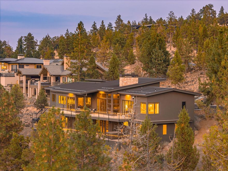 Your dream home awaits in the prestigious & gated North Rim neighborhood. A custom-built masterpiece, set on an acre backs to open space, offering privacy & access to scenic trails leading to the Deschutes River. Spanning over 6,000 Sq.Ft., this architectural gem has been thoughtfully reimagined to blend mid-century modern vibes w/ a distinct NW twist.Step inside to the expansive great room where reclaimed wood surrounds you from beneath your feet to the handcrafted built in shelves & fireplace, exuding warmth and timeless charm. As expected, the kitchen features state of the art appliances & stunning Carrara marble countertops.The primary suite, 2nd bedroom, & office round out the main level while multiple outdoor spaces provide the backdrop to take in the huge mtn views! The finished walk-out lower level offers 2 additional bedrooms, media room, bar, & bonus rooms for music, art, or play. A 4-car garage completes this luxurious package, providing ample space for vehicles & toys!