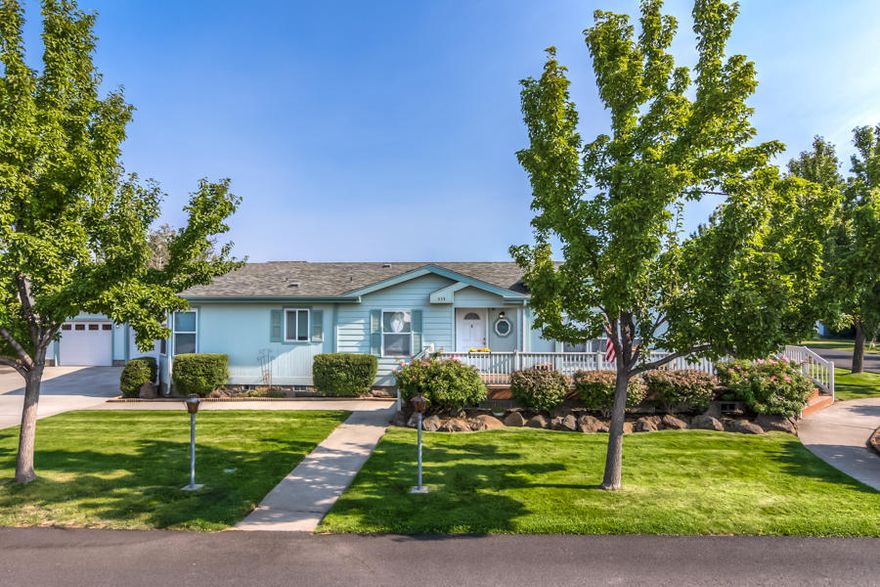 Ideal location on double corner lot in Desert Meadows/Ni Lah Sha Village
Light and bright!  Spacious open layout manufactured home with large outdoor living space.  Updated carpet and vinyl plank flooring, ample kitchen area with double pantry, lots of counter space, cabinets and tiled island.  Beautifully landscaped yard, sweeping wrap around deck, large slate patio, perfect for relaxing and entertaining guests.  Find a place for everything with all of the available storage space! Conveniently located to shopping and downtown Redmond. Exterior amenities include triple car garage, extra large driveway, 2 storage sheds, RV parking and in-ground sprinkler system.