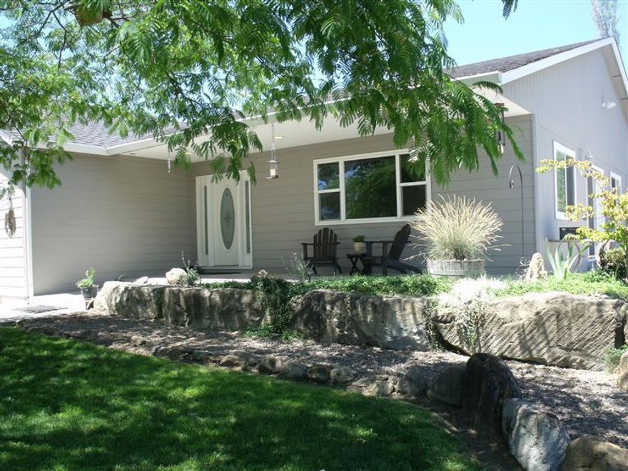 Welcome home. Single level 4/2 living with a vaulted open living, kitchen, dining floor plan. Cool, quiet 4th bedroom 370 sq ft studio has views of the lush property and city lights.On 1.17 level acres with a four stall horse barn & gravity fed irrigation year round creek & pond with beautiful views of the valley, standing oat field & city lights. Enjoy the sounds.