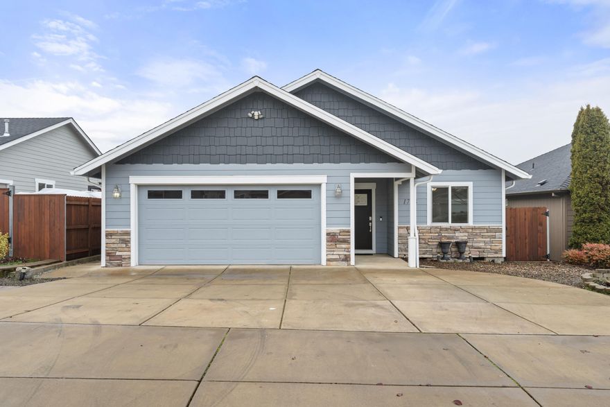 Beautiful single-level home in desirable East Medford offering comfort, functionality, and low-maintenance living. This 3-bedroom, 2-bath residence features over 1,400 square feet with a spacious and inviting layout. The large living room flows seamlessly into the open kitchen, which offers a great-sized workspace, soft-close cabinetry, and an abundance of storage. A long hallway provides separation and privacy for the bedrooms. Enjoy the low-maintenance backyard highlighted by gorgeous concrete work, perfect for relaxing or entertaining. Additional features include solar tubes for added natural light, a great-sized driveway, and a fully fenced yard. A well-designed home in a fantastic location ready for its next owner.