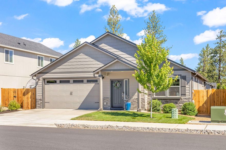 Welcome to this pristine 3-bedroom, 2-bathroom home in McKenzie Meadows Village. Completed in 2021 and impeccably maintained by its original owner, this residence boasts fresh exterior paint from 2024, offering a move-in-ready experience. The thoughtful layout includes an optional front-facing office, perfect for work or relaxation. The open living space flows into a modern kitchen, ideal for gatherings. Step outside to a beautifully landscaped backyard with a sprinkler system, a unique covered patio for year-round enjoyment, and a sliding glass door off the primary bedroom for private outdoor access. Just steps away lies a neighborhood park with a covered area, playground, and open lawn. Centrally located near all three Sisters District schools, national forest trails, walking paths, and the vibrant charm of downtown Sisters, this home is currently priced as the lowest  detached single-family property within Sisters.