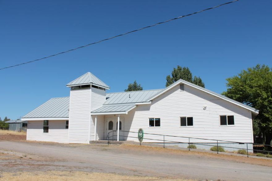 Your church in Bly, Oregon.  Once a bustling wood industry town,  now a slower paced community catering to the local ranchers, farmers and retired folks living gracefully among the pines and fresh air. The church has a large chapel with support offices.  The chapel has a large stage area. There are restrooms, a kitchen, a serving bar, a separate room for dining.  The exit doors are equipped with panic hardware. The church is equipped with three Mitsubishi air conditioner/heating units. The heating and A/C bills are less than a 100.00 dollars a month. There's plenty of parking available around the building.  Located between Klamath Falls and Lakeview, this is a must see. Church is tax exempt. Taxes may change with new owner.