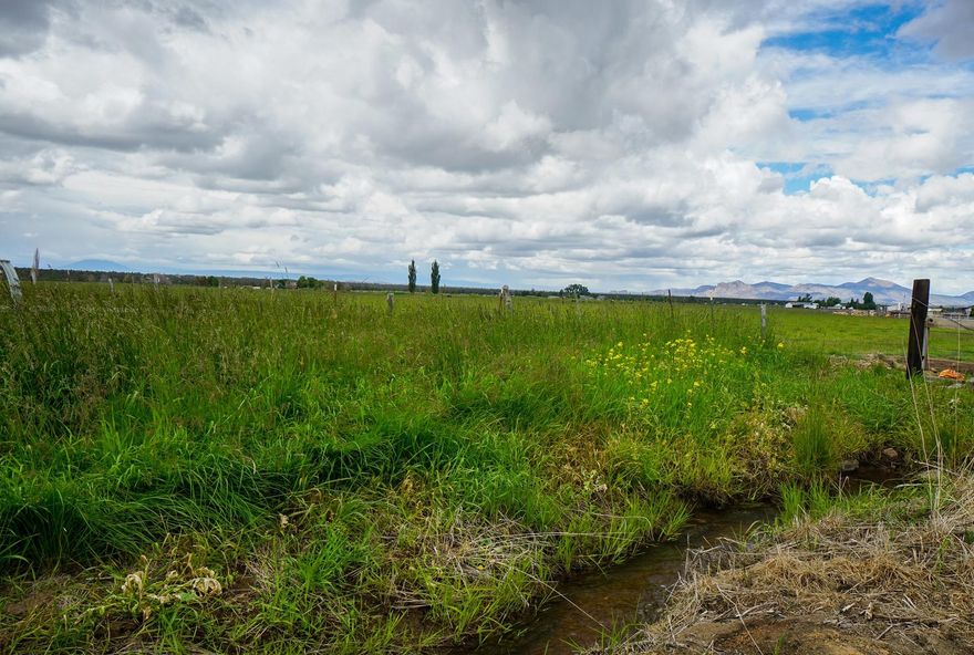 Beautiful mountains views from this 33.80 acre parcel with 33.20 acres of COID water rights under a wheelline. Great central location for your custom built home only 10 miles to Redmond, 11 miles to Prineville and 21 Miles to Bend Costco. Seller will drill a well with an acceptable offer.