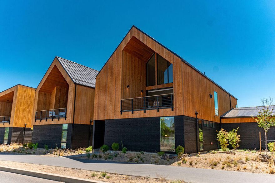 Stunning Mountain Modern townhome w/Cascade Mountain views in the sought-after community of Tetherow. Completed in 2021 & immaculately maintained, this home was designed to fully-embrace the Bend lifestyle...walk out your door & access phenomenal trail systems, world-class golf, 2 pools, fabulous dining & fitness center. Filled w/natural light, warm wood accents & high-end finishes, the efficient reverse-living floorplan takes full advantage of views. Great Rm w/soaring ceilings, gas fp, and dramatic oversized sliders opening to the covered deck blends indoor/outdoor living seamlessly. Chef's kitchen w/solid surface countertops, Thermador appl, and an expansive built-in bar w/warming drawer & beverage fridge. Primary Suite w/spa-like bath, radiant floors, soaking tub, tiled shower & walk-in closet. Entry level: 2 En Suite BR, laundry/mudroom, & access to a FANTASTIC oversized 3-car garage. Less than 20 minutes to Mt. Bachelor & excellent proximity to all Westside schools & amenities.